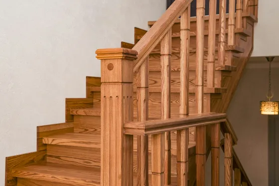 Oak staircase with turned balusters, a newel post and solid wood treads